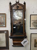 A wooden cased pendulum wall clock with applied advertising for The Regent Hotel Garage of