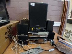 A Panasonic A/V control receiver with DVD/CD player along with five speaker, subwoofer, and remote