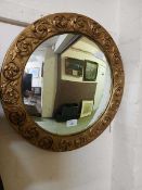 A gilt framed convex wall mirror