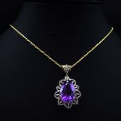 A SILVER-GILT AND AMETHYST PENDANT.