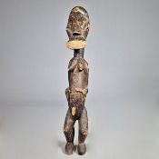 A CARVED AFRICAN FIGURE.
