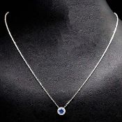 AN 18CT WHITE GOLD SAPPHIRE AND DIAMOND CLUSTER PENDANT.
