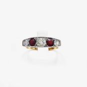 AN 18CT GOLD DIAMOND AND RED STONE DRESS RING.