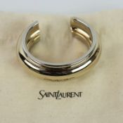 A SAINT LAURENT CHROME TWO TONE BANGLE.