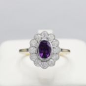 A 9CT GOLD AMETHYST AND DIAMOND CLUSTER RING.