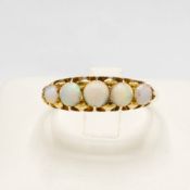 AN EARLY 20TH CENTURY YELLOW METAL OPAL RING.