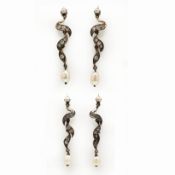 A PAIR OF WHITE METAL DIAMOND AND PEARL SET EARRINGS.