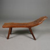 AN AFRICAN TRIBAL CARVED WOOD BENCH.