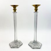 A PAIR OF GLASS COLUMNED BRASS CAPPED CANDLESTICKS. (2).