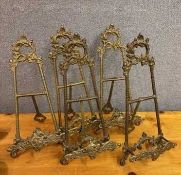 A collection of five gilt metal decorative small easels