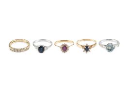 A collection of dress rings, comprising a sapphire and diamond three stone ring, stamped '14K',