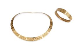 A yellow precious metal torque collar necklace and bangle suite, of tapered design, each decorated