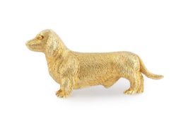 A dachshund brooch, of textured finish, stamped '14CT' and inscribed '10.12.38', length 3.5cm