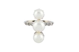A cultured pearl and diamond dress ring, designed as a trio of slightly graduated cultured pearls,