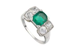 An emerald and diamond dress ring, the octagonal step-cut emerald claw set between pairs of old-