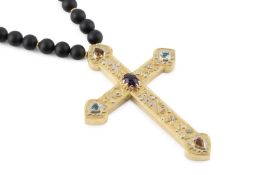 A vari gem-set cross pendant, applied with abstract geometric, star and scrolled wirework motifs,