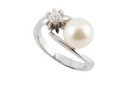 A cultured pearl and diamond dress ring, of crossover design, the round brilliant-cut diamond in