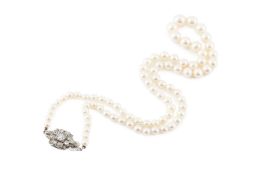 A cultured pearl necklace with diamond set clasp, designed as a single strand of graduated