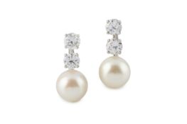 A pair of cultured pearl and diamond ear clips, each designed as a single cultured pearl