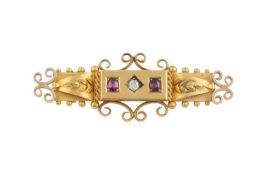 An Edwardian diamond and gem set panel brooch, the elongated stepped rectangular panel centred
