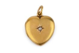 An Edwardian diamond set locket pendant, of heart-shaped design, centred with an old-cut diamond
