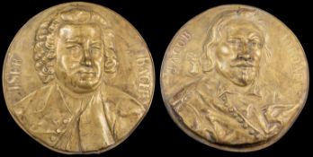 Two circular embossed wall plaques of composers