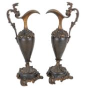 A pair of bronze ewers, together with two porcelain figural groups