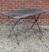 A garden table with a teak slatted top