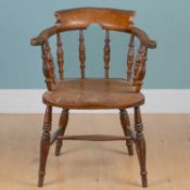 A 19th century elm-seated smoker's chair