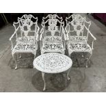 A set of six painted metal garden chairs with a low table