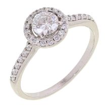 A diamond ring, with larger central round brilliant cut diamond with diamond shoulders, in