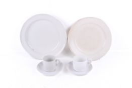 Six pieces of cream and white glazed military dinner ware.