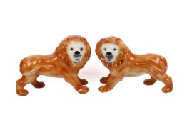 A pair of Victorian Staffordshire pottery standing lions.