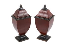 A pair of solid wooden urn shaped ornaments.