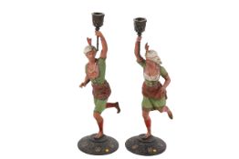 A pair of continental cold painted spelter figural candlestick holders.