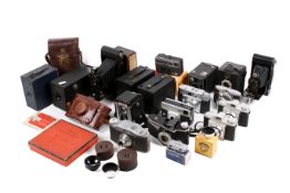 A collection of assorted vintage film cameras and accessories.