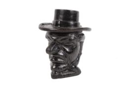 A late 19th century cast iron tobacco jar modelled as Mr Punch. His hat forming the cover.