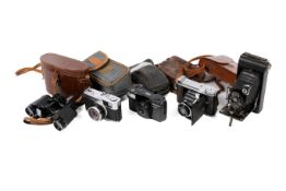 A group of four assorted cameras and a pair of vintage binoculars.