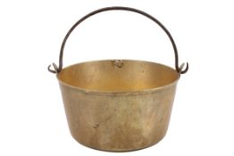 A vintage brass jam pan with iron handle.