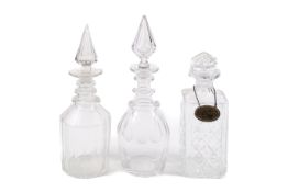 Three assorted glass decanters.