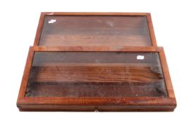 A pair of stained pine tabletop display cases.