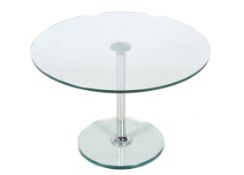 A glass top round coffee table.