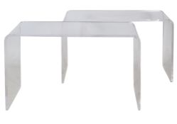 A pair of transparent plastic tables.