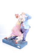 A contemporary paper mache sculpture of a couple dancing.