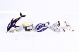 A group of four assorted Royal Crown Derby paperweights and a Royal Worcester candle holder.