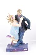 A contemporary paper mache sculpture of a couple dancing.