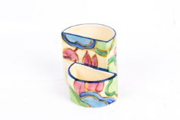 A circa 1930s Clarice Cliff Bizarre match strike and cigarette holder.