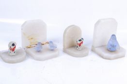 Two pairs of white marble bookends. One pair topped with frosted moulded glass birds, H12.