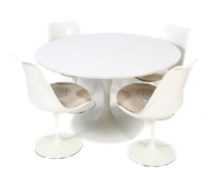 A vintage white metal 'Tulip' table and four chairs.