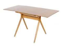 A mid-century Kandya drop leaf kitchen table. With laminated bend wood frame and splayed supports.